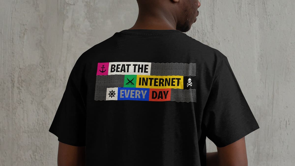 Toucan International - Visual Identity 1 Black t-shirt with colourful 'Beat the Internet every day' slogan.