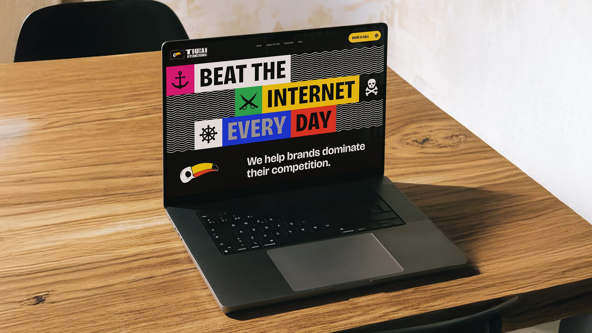 Laptop displaying vibrant Toucan International website design
