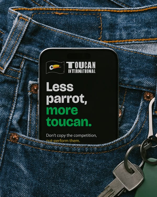 Less parrot, more toucan message on a social media post on a phone in the back pocket of someone's jeans.