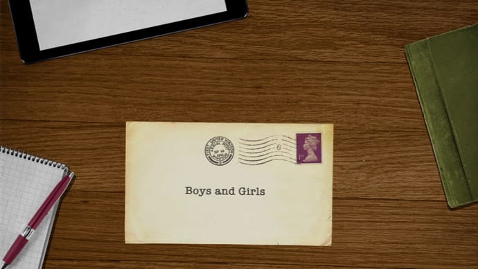 Animation still showing an old fashioned envelope on a wooden desk addressed to ‘Boys and Girls’.