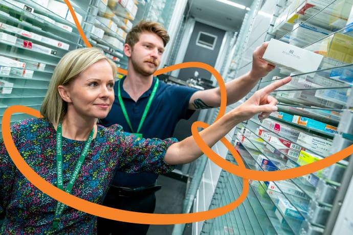 a male and female pharmacist dispensing medication