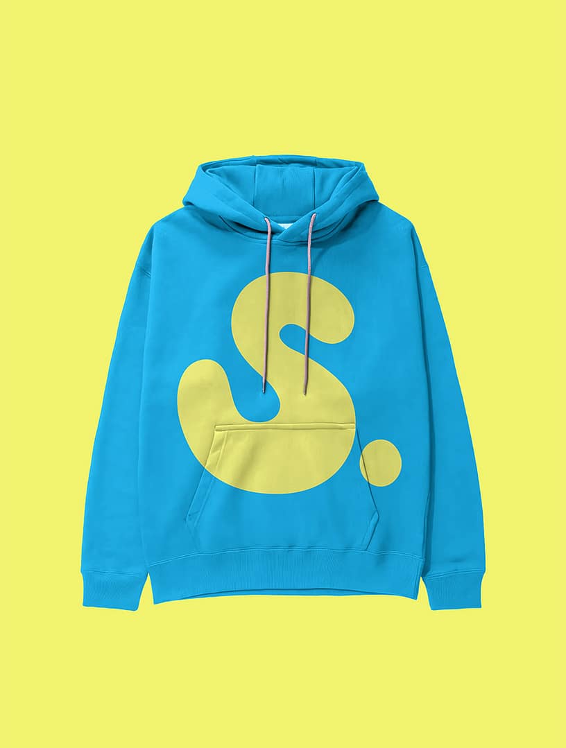 Bright turquoise SMEL hoodie displayed against a yellow background. The hoodie features a large neon yellow "S." logo that stretches across the chest and pocket, with contrasting white drawstrings.