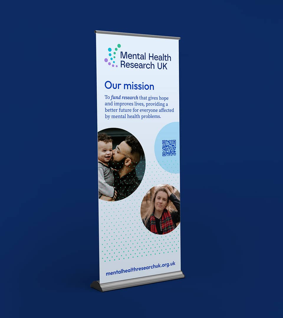 Another banner for Mental Health Research UK, speaking about their mission, this time with lighter hues of blue and dotted patterns are used. A father-son, and a lady are displayed. The web address of the research project is given at the bottom,“mentalhealthresearchuk.org.uk”.